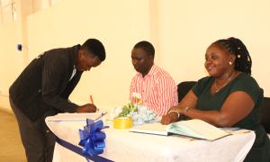 Faculty Of Engineering Library staff assisting a participant with registration during the International Open Access Week celebrations at the Faculty of Engineering Library, Busitema University, on 20th October 2025.