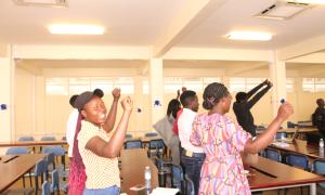 Participants engage in a stretching exercise during Open Access Week at the Busitema Faculty of Engineering Library on 20th October 2025.